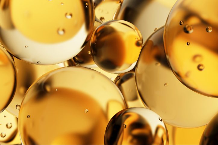Transparent yellow oil drops, bubbles, molecules. Close-up. 3D pattern. Healthcare and medicine. Cosmetic products for skin care. Citrus. Vitamin C.